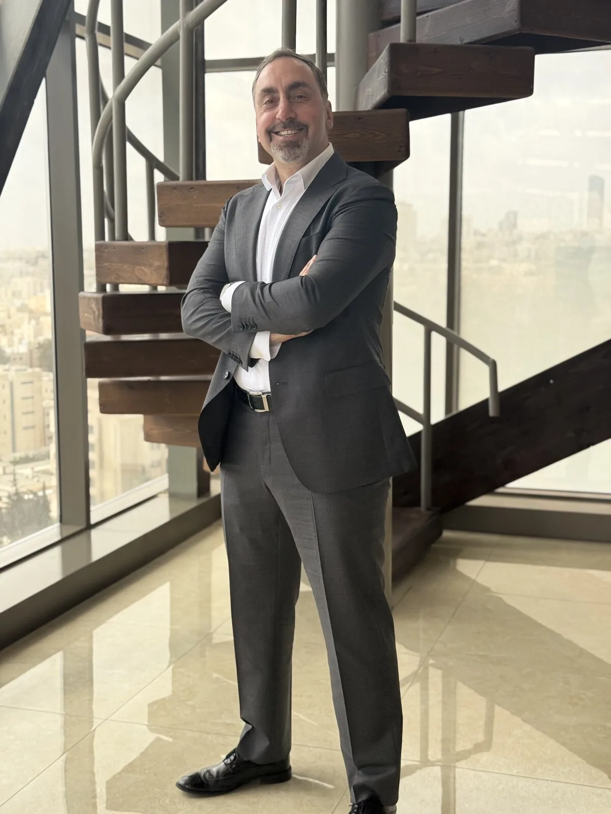 Zahi Abdein standing in a light-filled professional interior